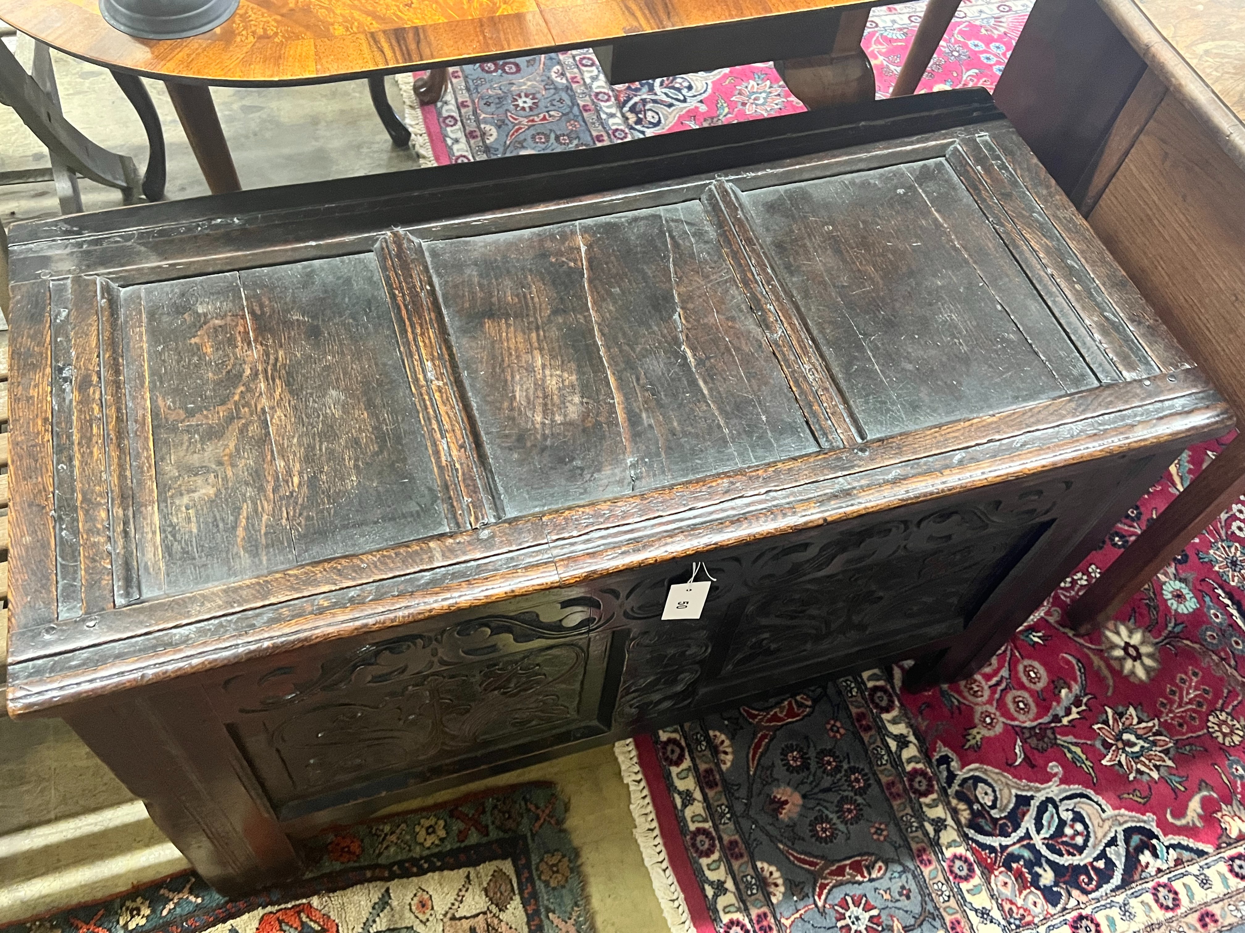 An 17th / 18th century oak coffer, with carved twin panelled front, width 103cm depth 50cm height 61cm